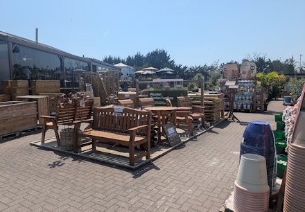 Longacres Bourne Valley wooden outdoor furniture display with wooden benches and companion seating